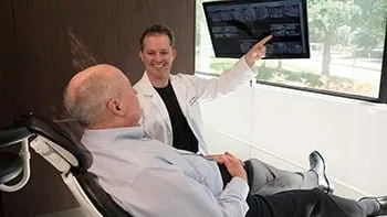 Dr. McRay showing patient his diagnosis from the digital xrays taken