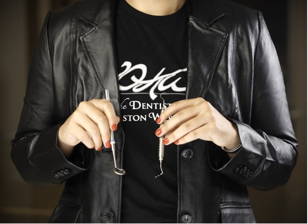 person holding dental tools